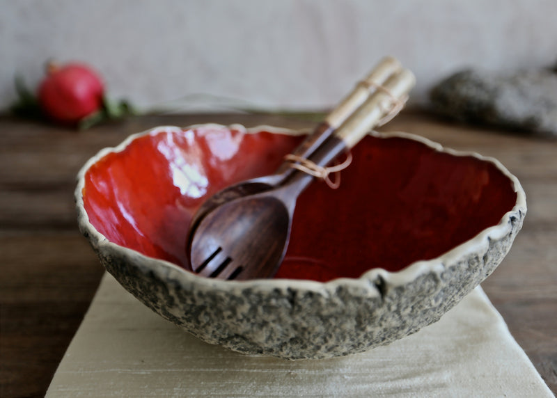 pottery salad bowl with salad spoons