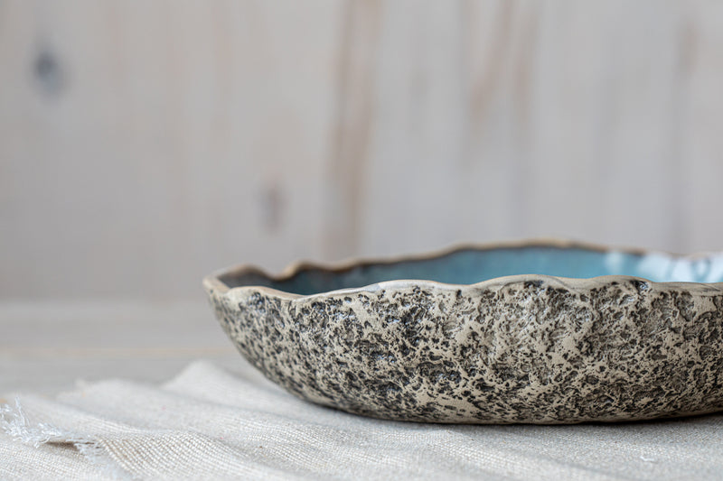 Detailed handwork on exterior of handmade ceramic serving bowl 