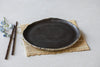 Black ceramic plate, hand made, stone like edges, es glazed surface