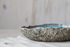Detailed handwork on exterior of handmade ceramic serving bowl 